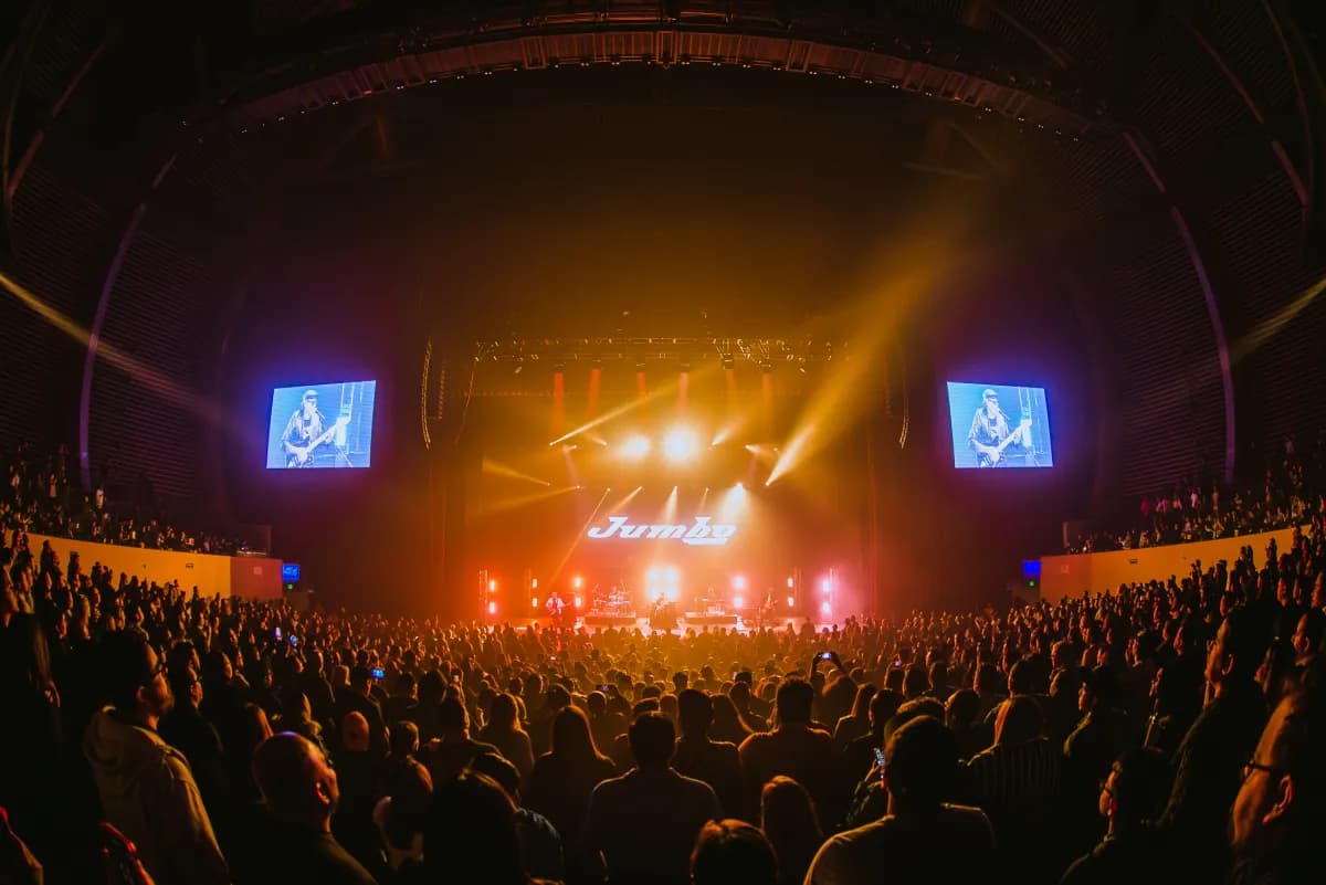 Wide fisheye shot of packed Jumbo concert arena with massive crowd