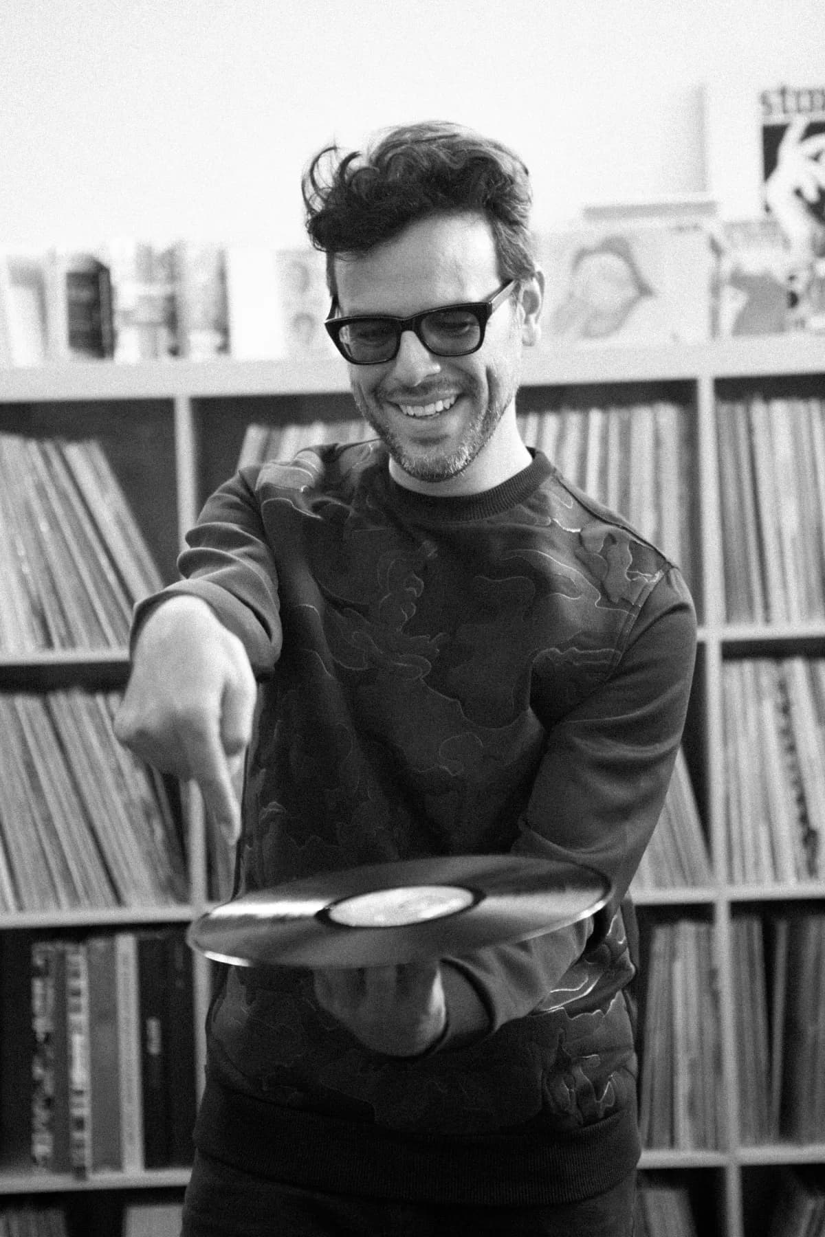 Clemente Castillo smiling and spinning a vinyl record